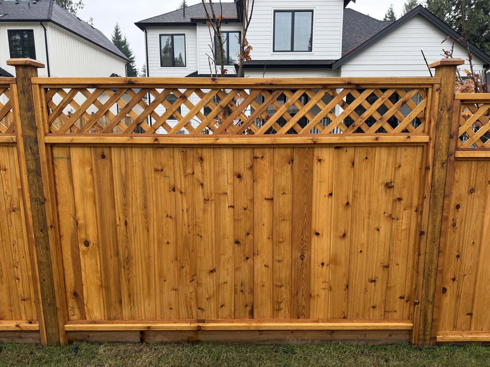 Close view of a cedar fence panel with diagonal lattice top